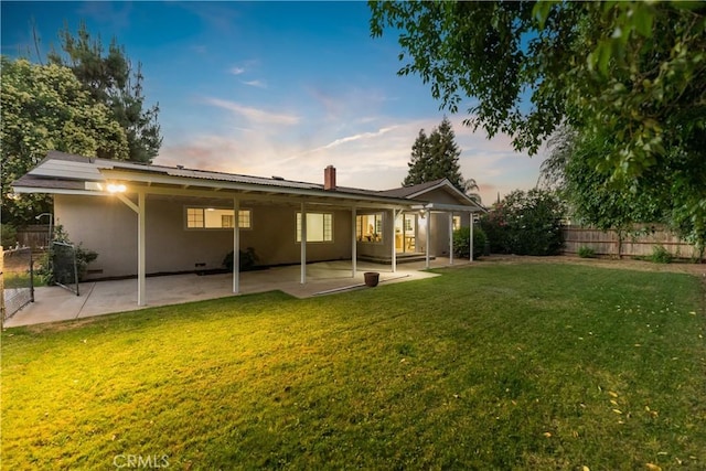 6330 N Wilson Ave, Fresno, CA 93704 - back of house at dusk featuring a patio area and stucco siding
