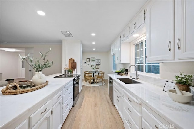6330 N Wilson Ave, Fresno, CA 93704 - kitchen featuring stainless steel appliances, light wood-type flooring, white cabinets, and recessed lighting