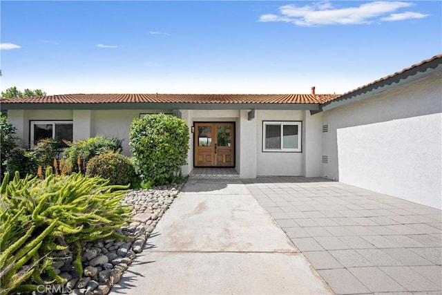 9211 Regency Way, Rancho Cucamonga, CA 91701 - doorway to property with french doors, stucco siding, and a tile roof