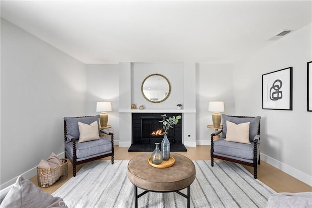 9211 Regency Way, Rancho Cucamonga, CA 91701 - sitting room featuring a tile fireplace and wood finished floors