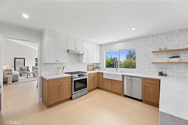 9211 Regency Way, Rancho Cucamonga, CA 91701 - kitchen featuring stainless steel appliances, under cabinet range hood, light countertops, decorative backsplash, and recessed lighting