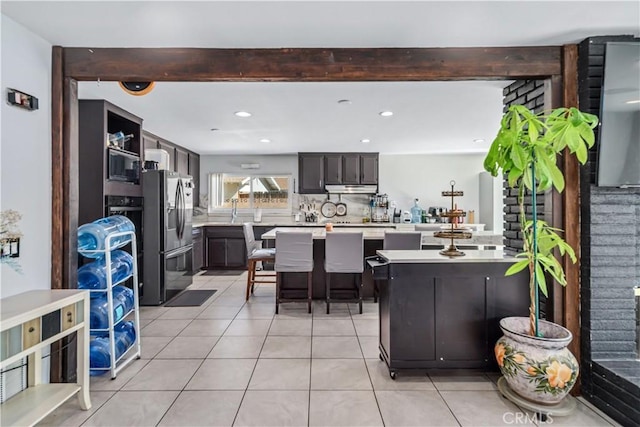 43657 21st St W, Lancaster, CA 93536 - kitchen featuring stainless steel fridge with ice dispenser, under cabinet range hood, light tile patterned flooring, light countertops, and recessed lighting
