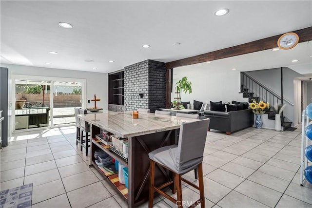 43657 21st St W, Lancaster, CA 93536 - kitchen featuring open shelves, a kitchen breakfast bar, light tile patterned floors, recessed lighting, and light stone countertops