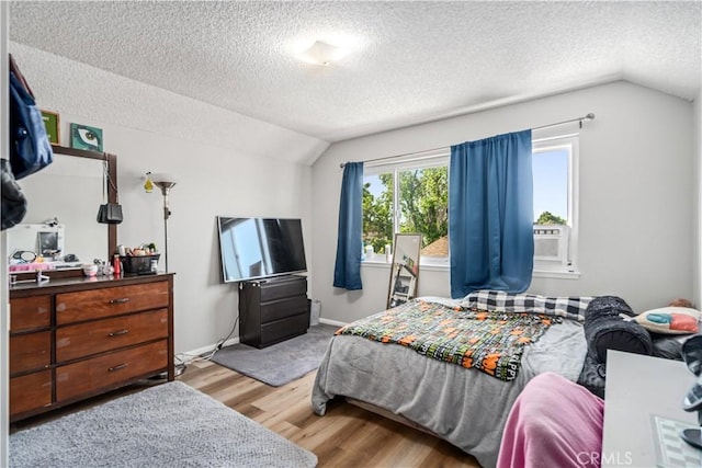 43657 21st St W, Lancaster, CA 93536 - bedroom featuring vaulted ceiling, a textured ceiling, and wood finished floors