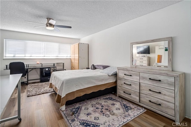 43657 21st St W, Lancaster, CA 93536 - bedroom with wood finished floors, a textured ceiling, and a ceiling fan