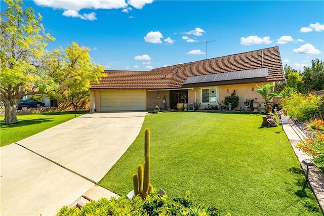 43657 21st St W, Lancaster, CA 93536 - view of front of house featuring an attached garage, a front yard, stucco siding, driveway, and solar panels
