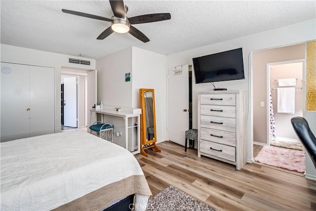 43657 21st St W, Lancaster, CA 93536 - bedroom with light wood-style flooring, a textured ceiling, and a ceiling fan