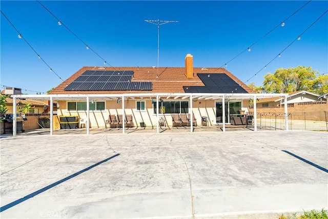 43657 21st St W, Lancaster, CA 93536 - back of property featuring a patio area, a fenced backyard, and roof mounted solar panels