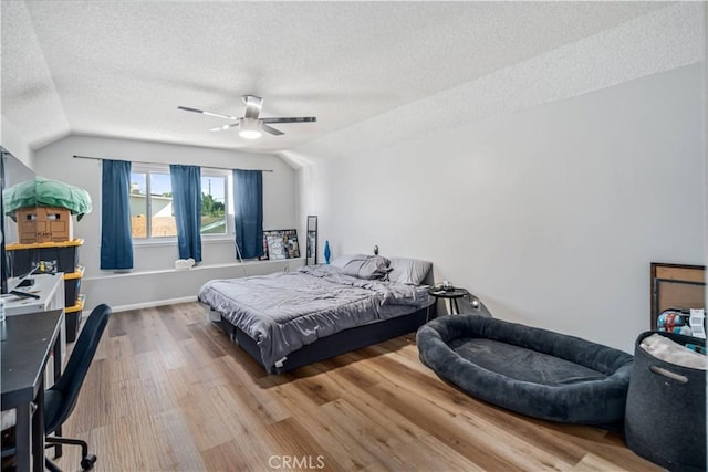 43657 21st St W, Lancaster, CA 93536 - bedroom featuring a textured ceiling, vaulted ceiling, wood finished floors, and a ceiling fan