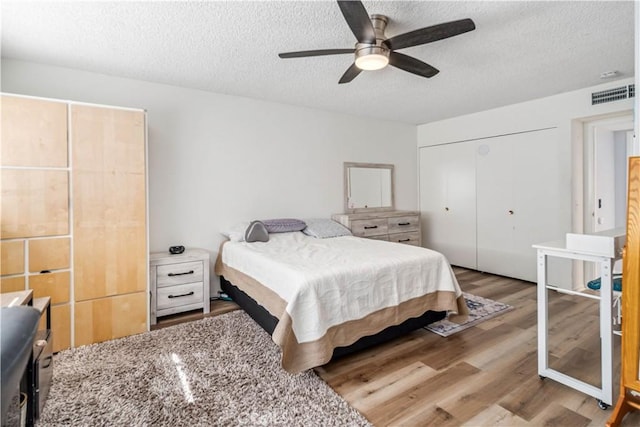 43657 21st St W, Lancaster, CA 93536 - bedroom with wood finished floors, a textured ceiling, a closet, and a ceiling fan