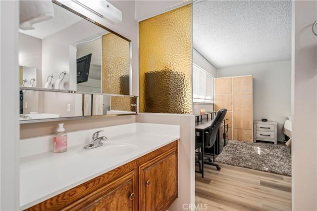 43657 21st St W, Lancaster, CA 93536 - bathroom featuring a textured ceiling, wood finished floors, and vanity