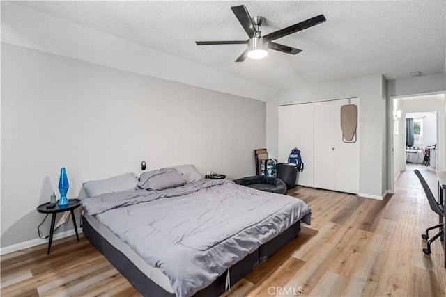 43657 21st St W, Lancaster, CA 93536 - bedroom with a textured ceiling, a closet, wood finished floors, and ceiling fan