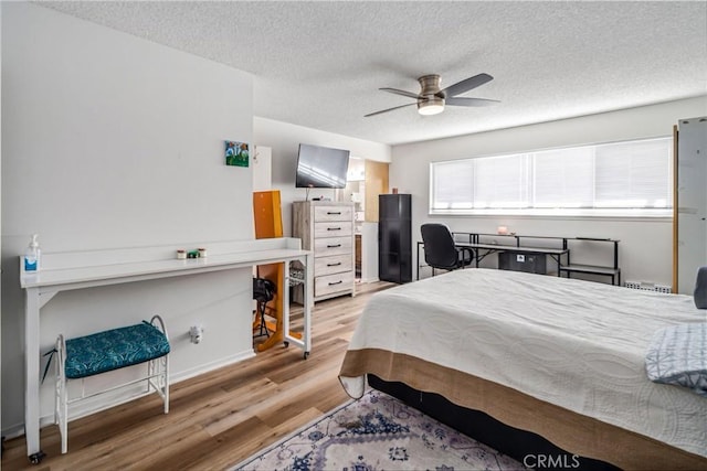 43657 21st St W, Lancaster, CA 93536 - bedroom with light wood-type flooring, a textured ceiling, and a ceiling fan