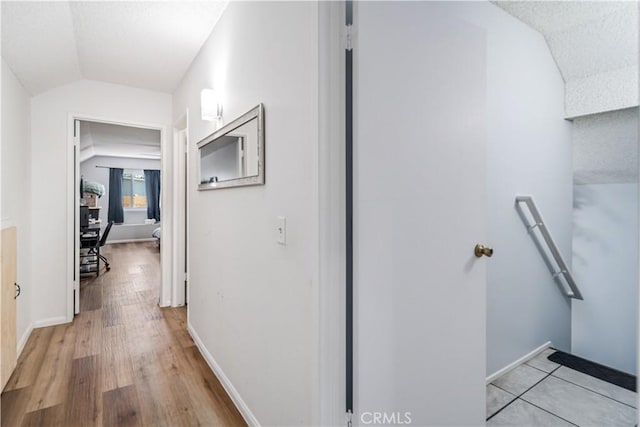 43657 21st St W, Lancaster, CA 93536 - hallway with vaulted ceiling, light wood-style floors, and an upstairs landing