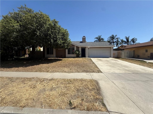 15569 Athol St, Fontana, CA 92335 - ranch-style home with an attached garage, concrete driveway, and a chimney