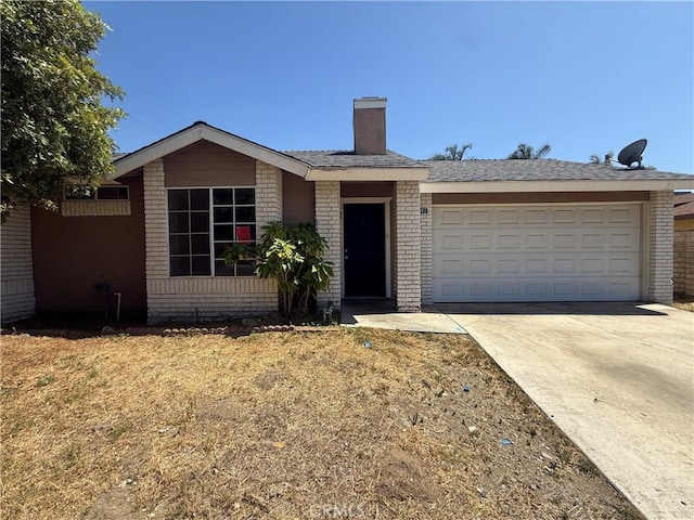 15569 Athol St, Fontana, CA 92335 - view of front of house featuring brick siding, concrete driveway, a chimney, and an attached garage
