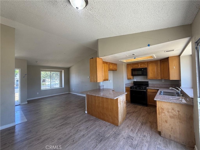 15569 Athol St, Fontana, CA 92335 - kitchen featuring black appliances, dark wood-type flooring, brown cabinetry, vaulted ceiling, and open floor plan