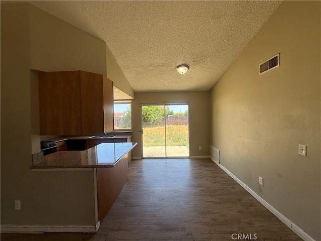 15569 Athol St, Fontana, CA 92335 - unfurnished dining area with a textured ceiling, dark wood-style flooring, and lofted ceiling