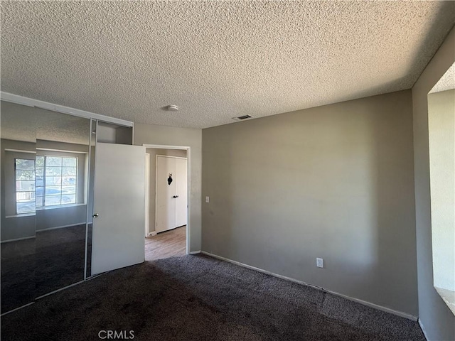 15569 Athol St, Fontana, CA 92335 - unfurnished bedroom with dark colored carpet, a textured ceiling, and a closet