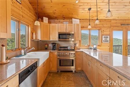 7385 Cosmit Ln, Julian, CA 92036 - kitchen featuring appliances with stainless steel finishes, light brown cabinets, plenty of natural light, vaulted ceiling, and backsplash