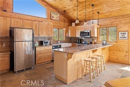 7385 Cosmit Ln, Julian, CA 92036 - kitchen with appliances with stainless steel finishes, light brown cabinets, high vaulted ceiling, wooden ceiling, and a kitchen bar