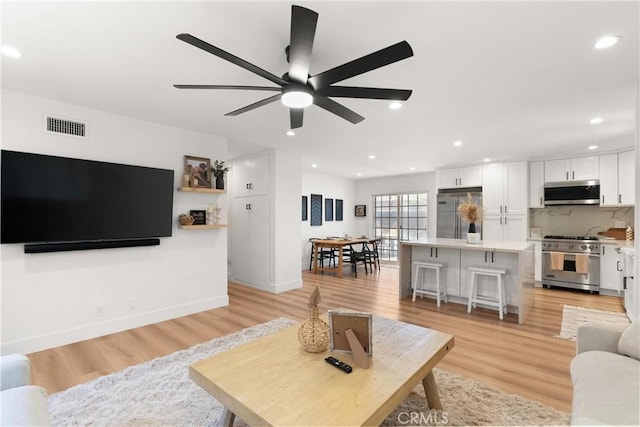 10171 Kukui Dr, Huntington Beach, CA 92646 - living room featuring light wood-style flooring, a ceiling fan, and recessed lighting