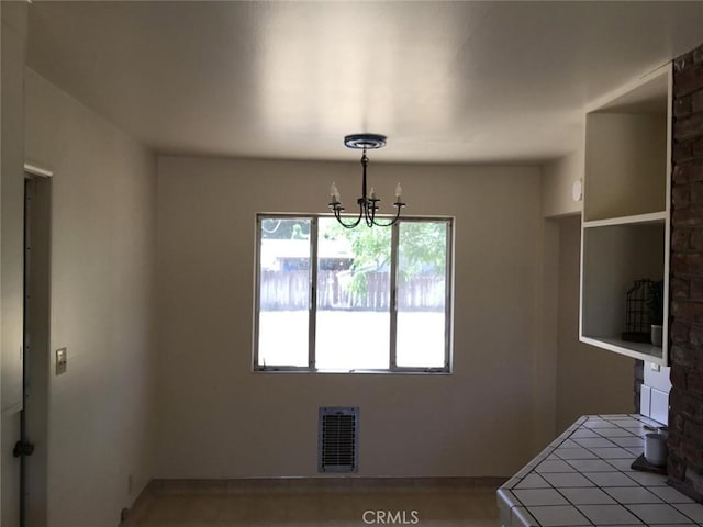 2911 Tahoe Dr, Merced, CA 95340 - unfurnished dining area with a chandelier and baseboards