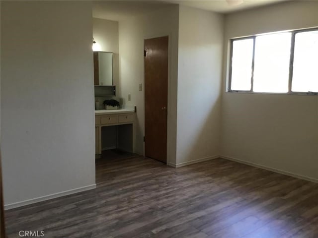 2911 Tahoe Dr, Merced, CA 95340 - unfurnished bedroom with dark wood-style flooring and baseboards