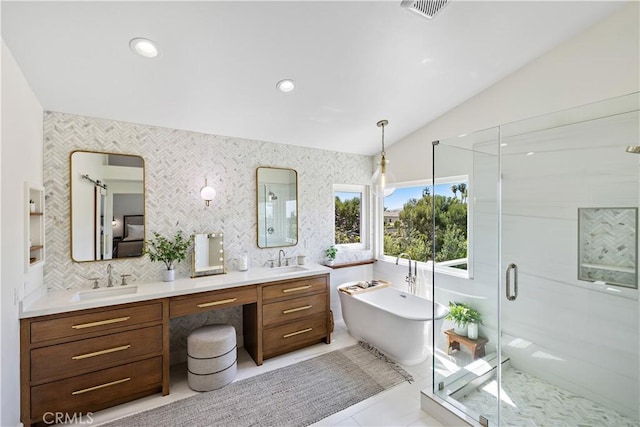 2 Sun Ter, Laguna Niguel, CA 92677 - full bath featuring double vanity, a freestanding tub, a shower stall, lofted ceiling, and recessed lighting