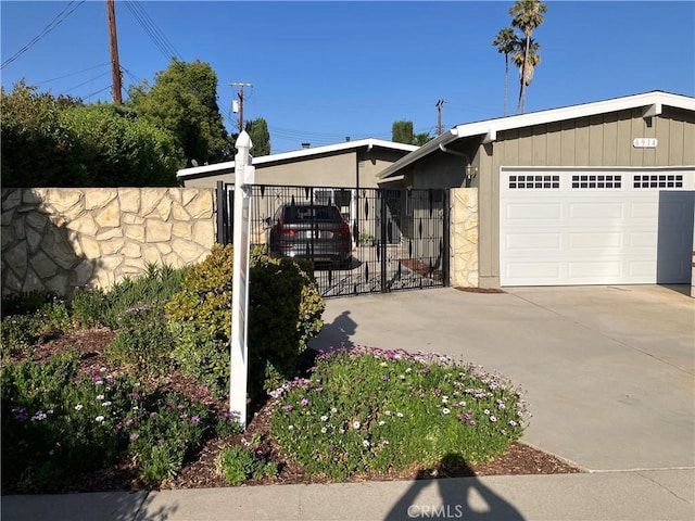 6914 Andasol Ave, Van Nuys, CA 91406 - view of home's exterior featuring concrete driveway, an attached garage, and a gate