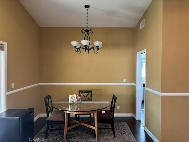 6914 Andasol Ave, Van Nuys, CA 91406 - dining space featuring a chandelier and wood finished floors