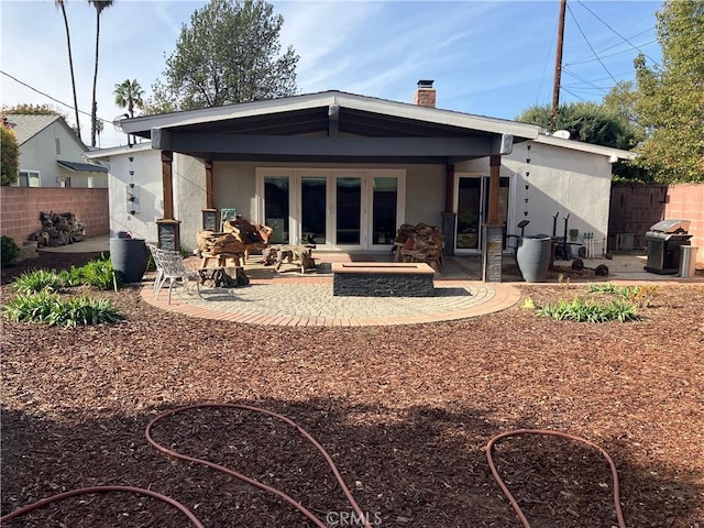 6914 Andasol Ave, Van Nuys, CA 91406 - rear view of property featuring stucco siding, a patio, and a chimney
