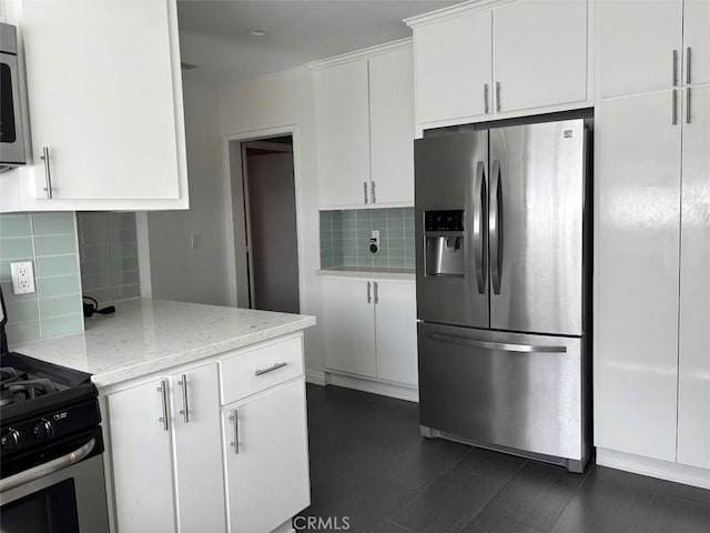 6914 Andasol Ave, Van Nuys, CA 91406 - kitchen featuring appliances with stainless steel finishes, backsplash, white cabinetry, and light stone counters