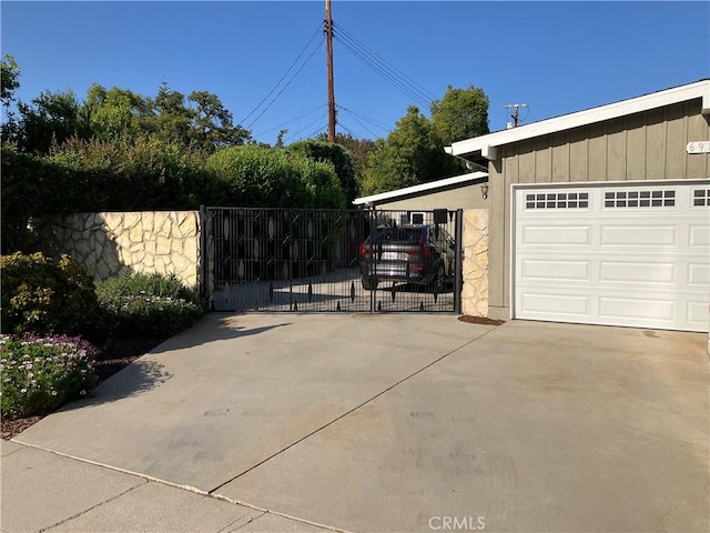 6914 Andasol Ave, Van Nuys, CA 91406 - garage with a gate, concrete driveway, and a carport