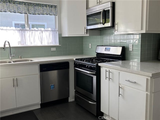 6914 Andasol Ave, Van Nuys, CA 91406 - kitchen with stainless steel appliances, white cabinetry, tasteful backsplash, and light stone countertops