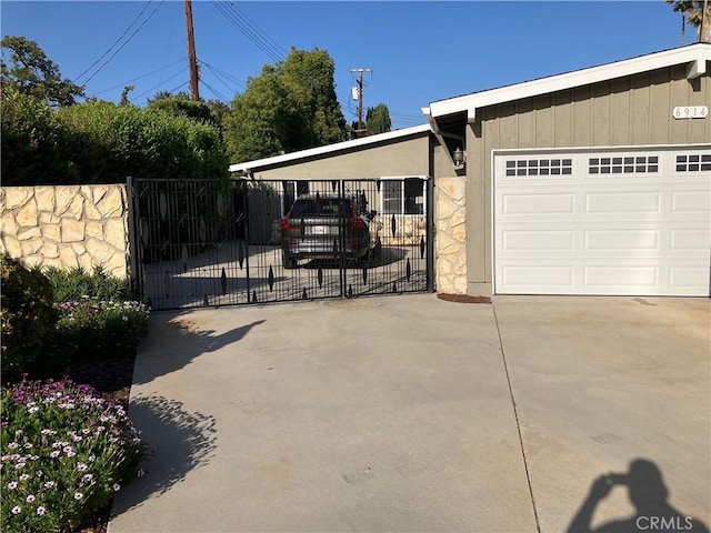6914 Andasol Ave, Van Nuys, CA 91406 - view of home's exterior featuring driveway, a gate, a carport, and stone siding