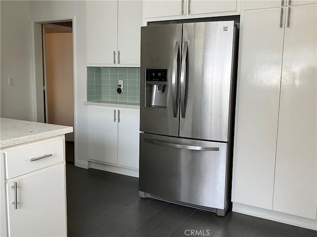 6914 Andasol Ave, Van Nuys, CA 91406 - kitchen with stainless steel fridge with ice dispenser, tasteful backsplash, white cabinets, and light stone counters
