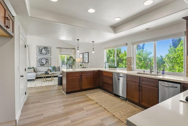 245 S Via Montanera, Anaheim Hills, CA 92807 - kitchen with dishwasher, light countertops, light wood-style flooring, a raised ceiling, and a peninsula