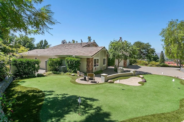 245 S Via Montanera, Anaheim Hills, CA 92807 - rear view of house with a putting green, a tiled roof, stone siding, a patio area, and stucco siding