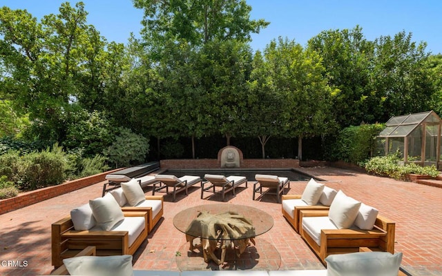 1241 S Oak Knoll Ave, Pasadena, CA 91106 - view of patio with an outdoor living space with a fire pit, a greenhouse, and an outdoor structure