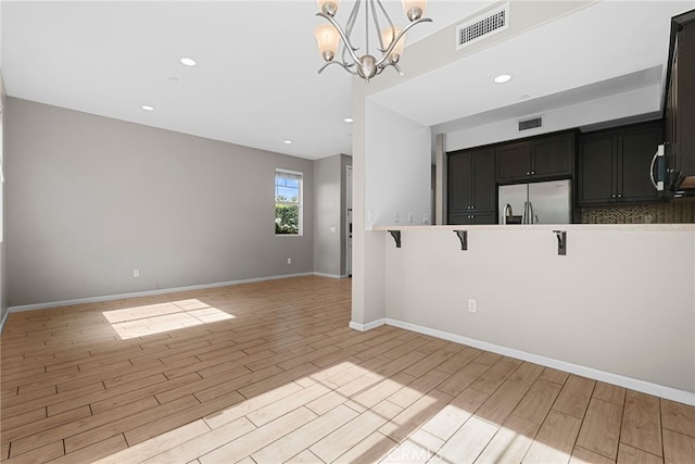 7600 N Courage Way, Van Nuys, CA 91405 - spare room with light wood-type flooring, recessed lighting, and a chandelier