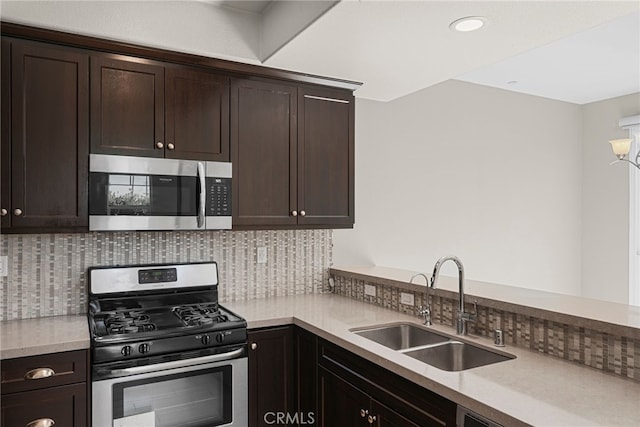 7600 N Courage Way, Van Nuys, CA 91405 - kitchen featuring stainless steel appliances, backsplash, dark brown cabinetry, light countertops, and recessed lighting