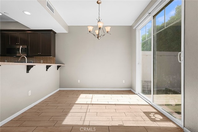 7600 N Courage Way, Van Nuys, CA 91405 - unfurnished dining area with light wood-style floors, a chandelier, and recessed lighting