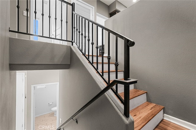 7600 N Courage Way, Van Nuys, CA 91405 - stairway featuring wood finished floors and a textured wall