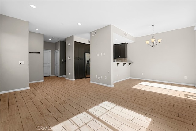 7600 N Courage Way, Van Nuys, CA 91405 - unfurnished living room featuring a chandelier, light wood-type flooring, and recessed lighting