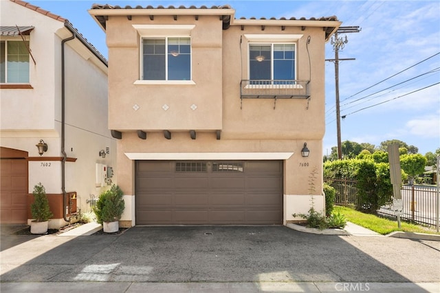 7600 N Courage Way, Van Nuys, CA 91405 - mediterranean / spanish home with an attached garage, stucco siding, and asphalt driveway