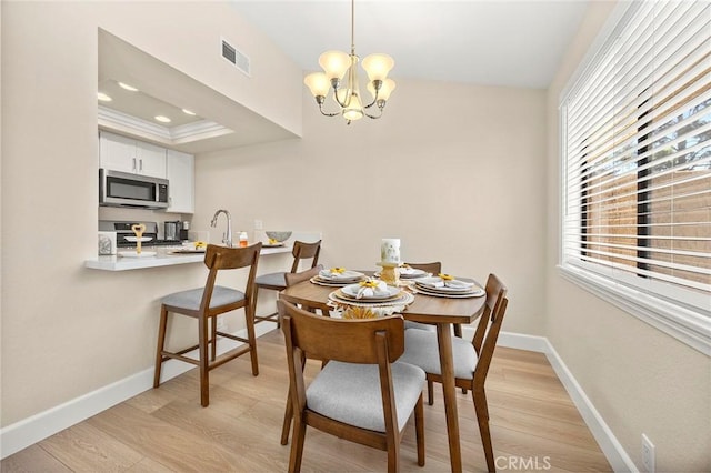 4692 Lakeview Ave Unit 8, Yorba Linda, CA 92886 - dining area featuring light wood finished floors, a chandelier, and a raised ceiling