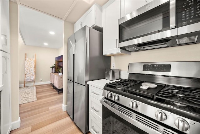 4692 Lakeview Ave Unit 8, Yorba Linda, CA 92886 - kitchen with stainless steel appliances, light wood-style flooring, white cabinets, light countertops, and recessed lighting