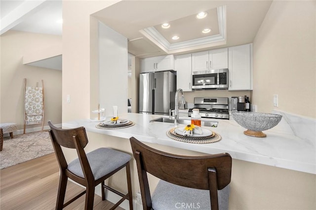 4692 Lakeview Ave Unit 8, Yorba Linda, CA 92886 - kitchen featuring stainless steel appliances, a peninsula, a kitchen bar, white cabinetry, and recessed lighting
