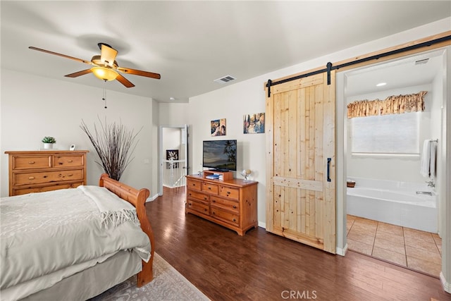 81 Mercantile Way, Ladera Ranch, CA 92694 - bedroom with a barn door, dark wood-type flooring, ensuite bathroom, and ceiling fan